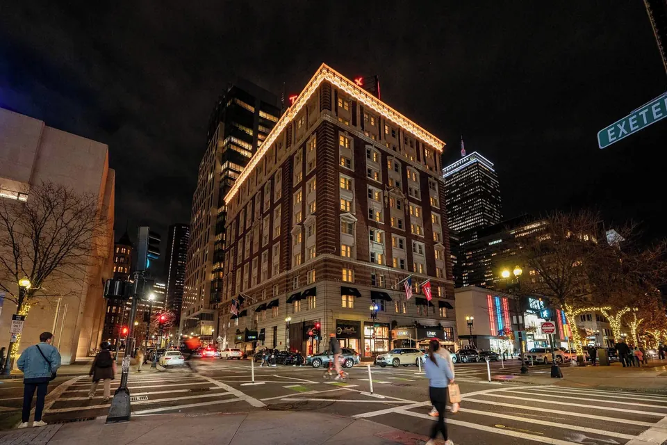 The Lenox Hotel brick facade at Boylston and Exeter Street at night via Expedia