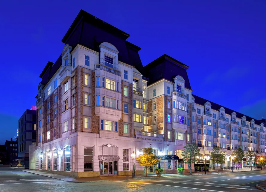 Hotel Commonwealth facade on Commonwealth Avenue at dusk via Expedia
