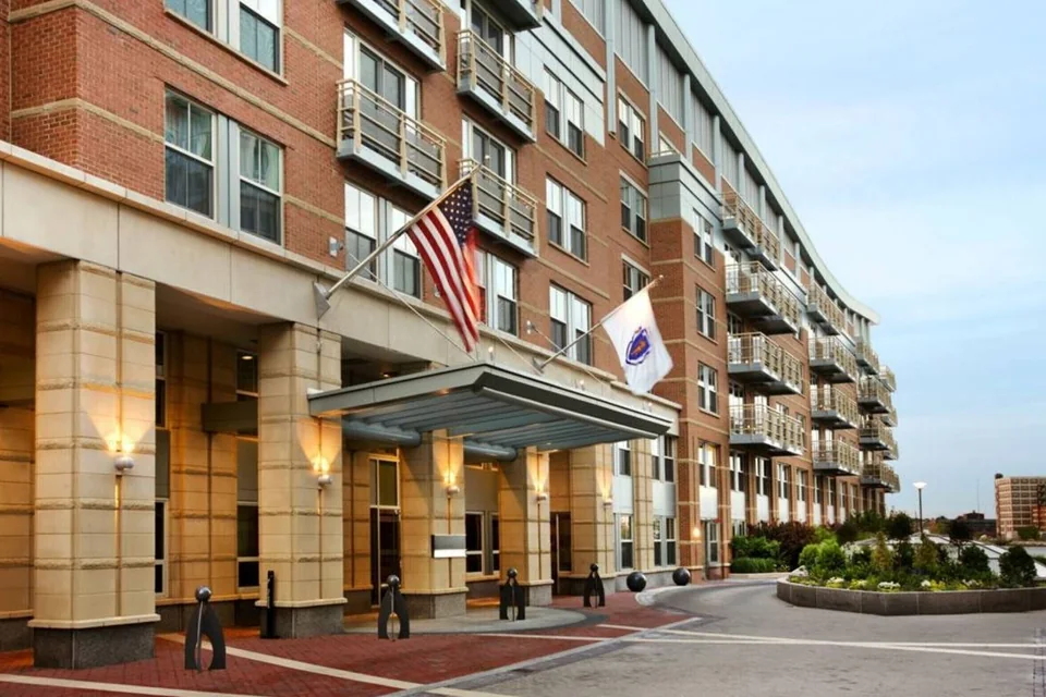 Battery Wharf Hotel brick facade and entrance with flags via Expedia