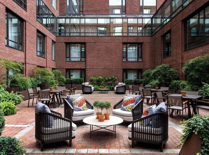 Brick courtyard terrace with lounge seating at Four Seasons Hotel Boston via Expedia