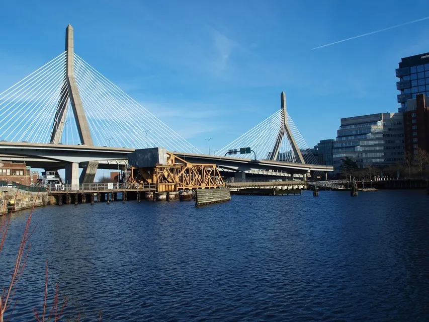 Zakim Bridge cable towers over the Charles River on a sunny day